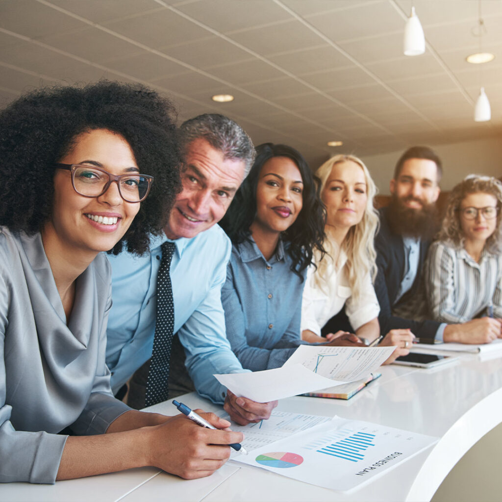 group of diverse coworkers smiling at work wealth management fairbridge retirement solutions